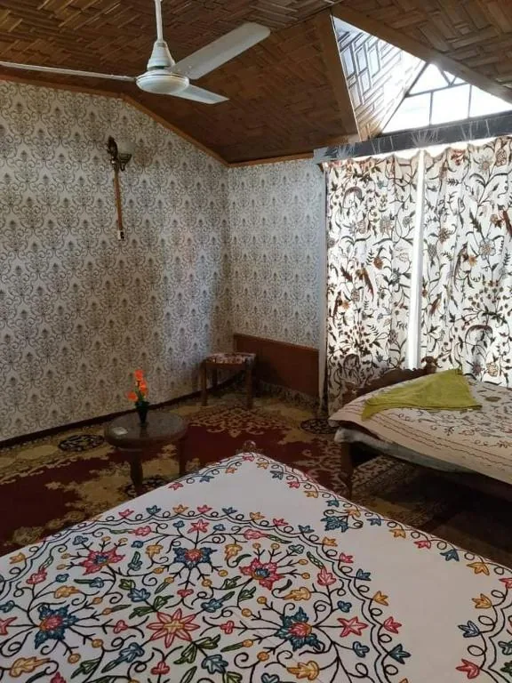 Honeymoon room with crewel-embroidered drapes and soft lamplight